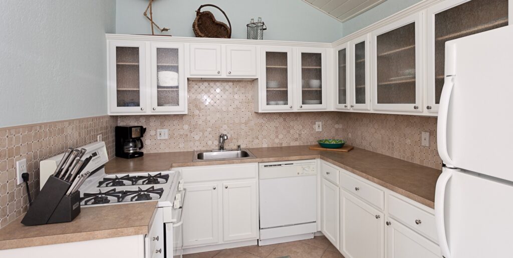 magnolia kitchen with fridge, stove, sink, dishwasher