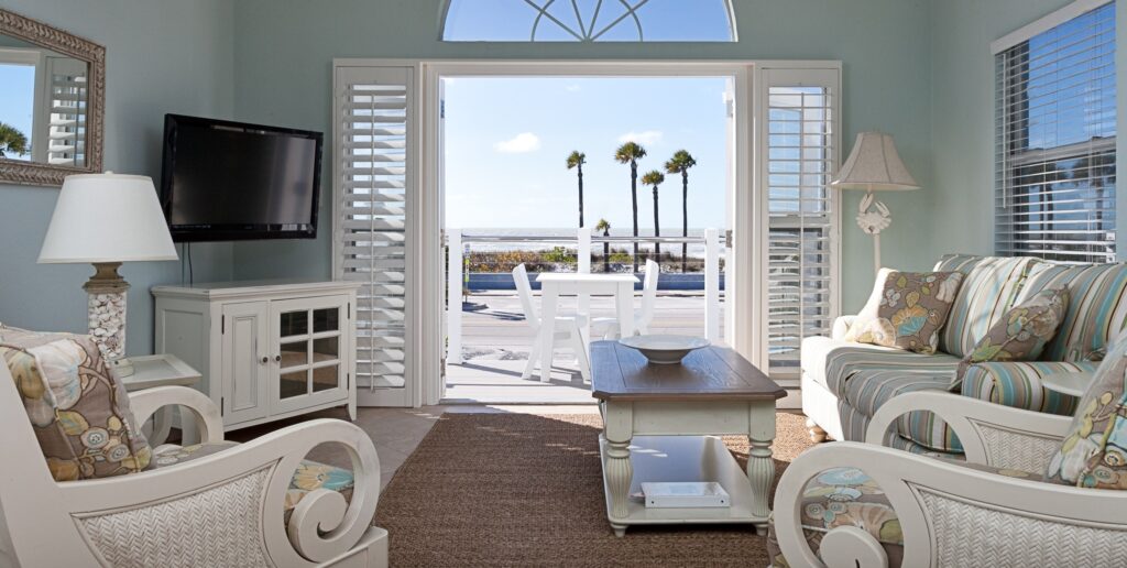 sitting area with sofas, TV and beach view