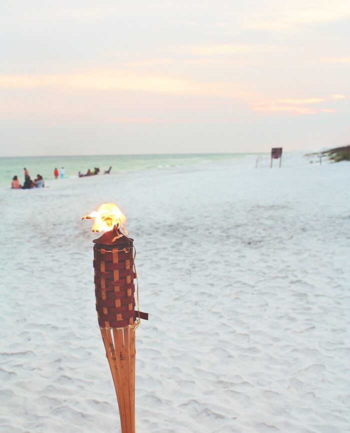 white beach with tiki torch