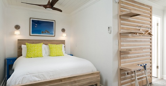 white bedroom with yellow pillows